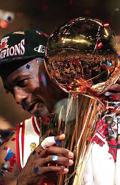Michael_Jordan_of_the_Chicago_Bulls_holds_the_NBA_Trophy_after.jpg